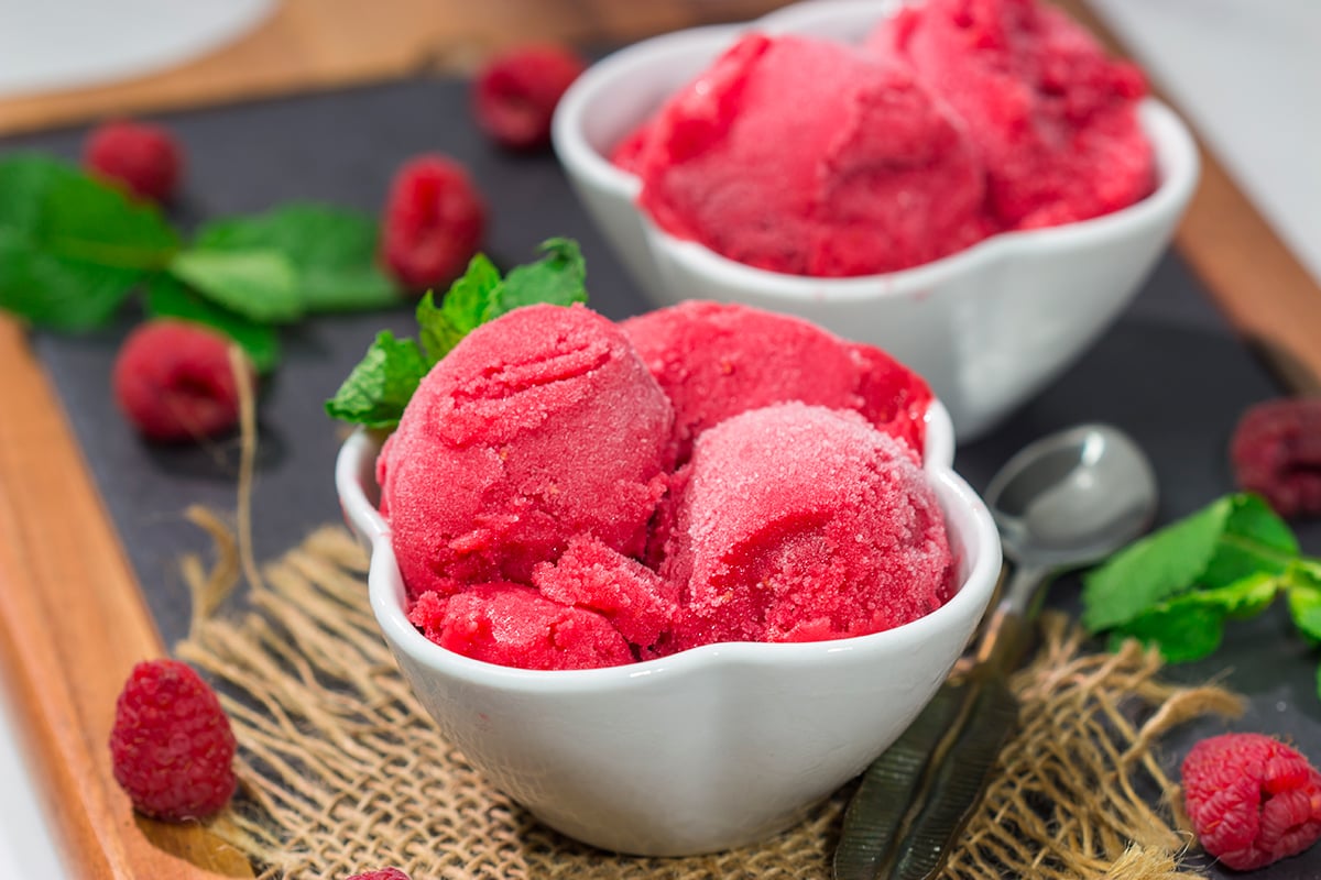 Looking for a tasty summer dessert? Whip up a batch of this Raspberry Sorbet! This dairy-free treat is perfect for warm summer evenings!