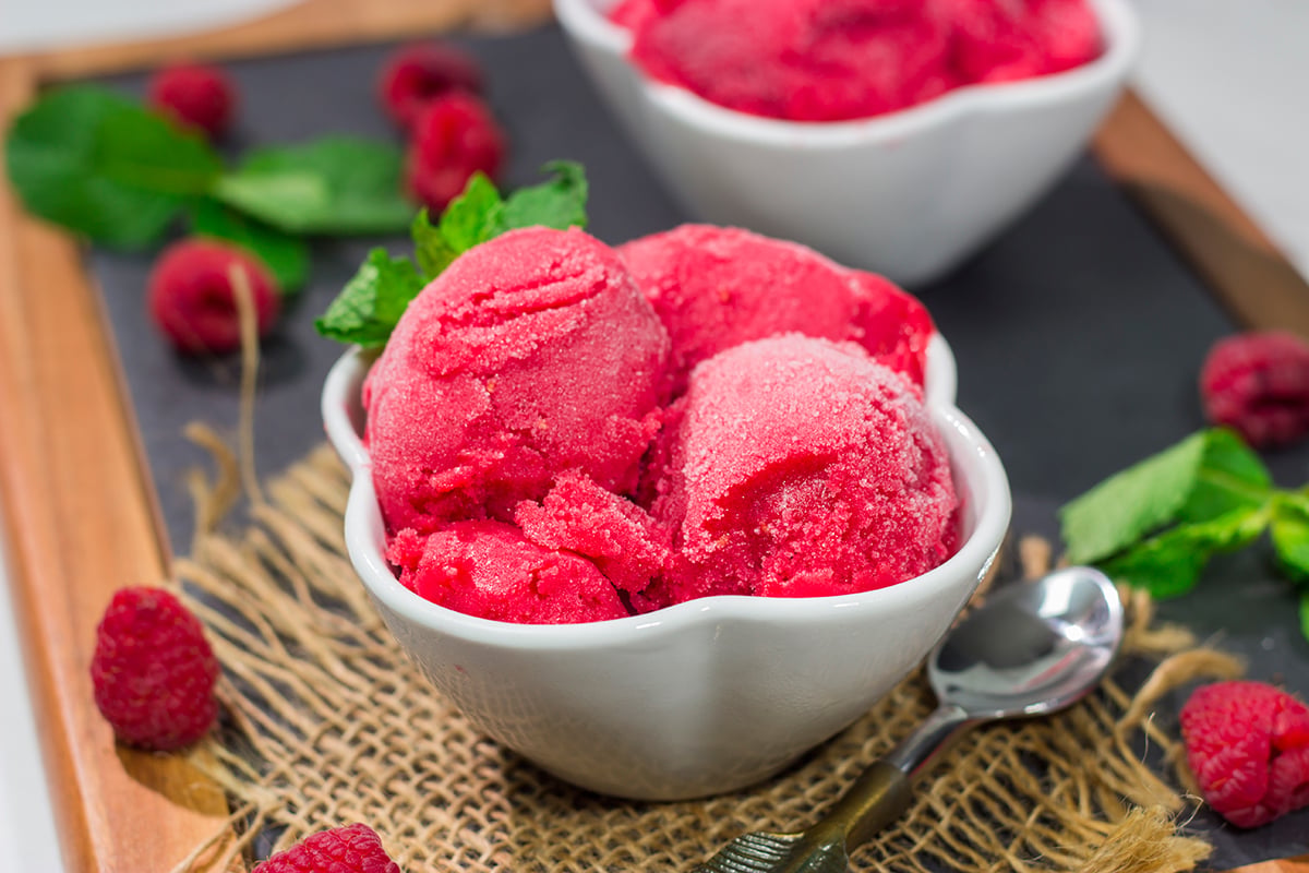 Looking for a tasty summer dessert? Whip up a batch of this Raspberry Sorbet! This dairy-free treat is perfect for warm summer evenings!