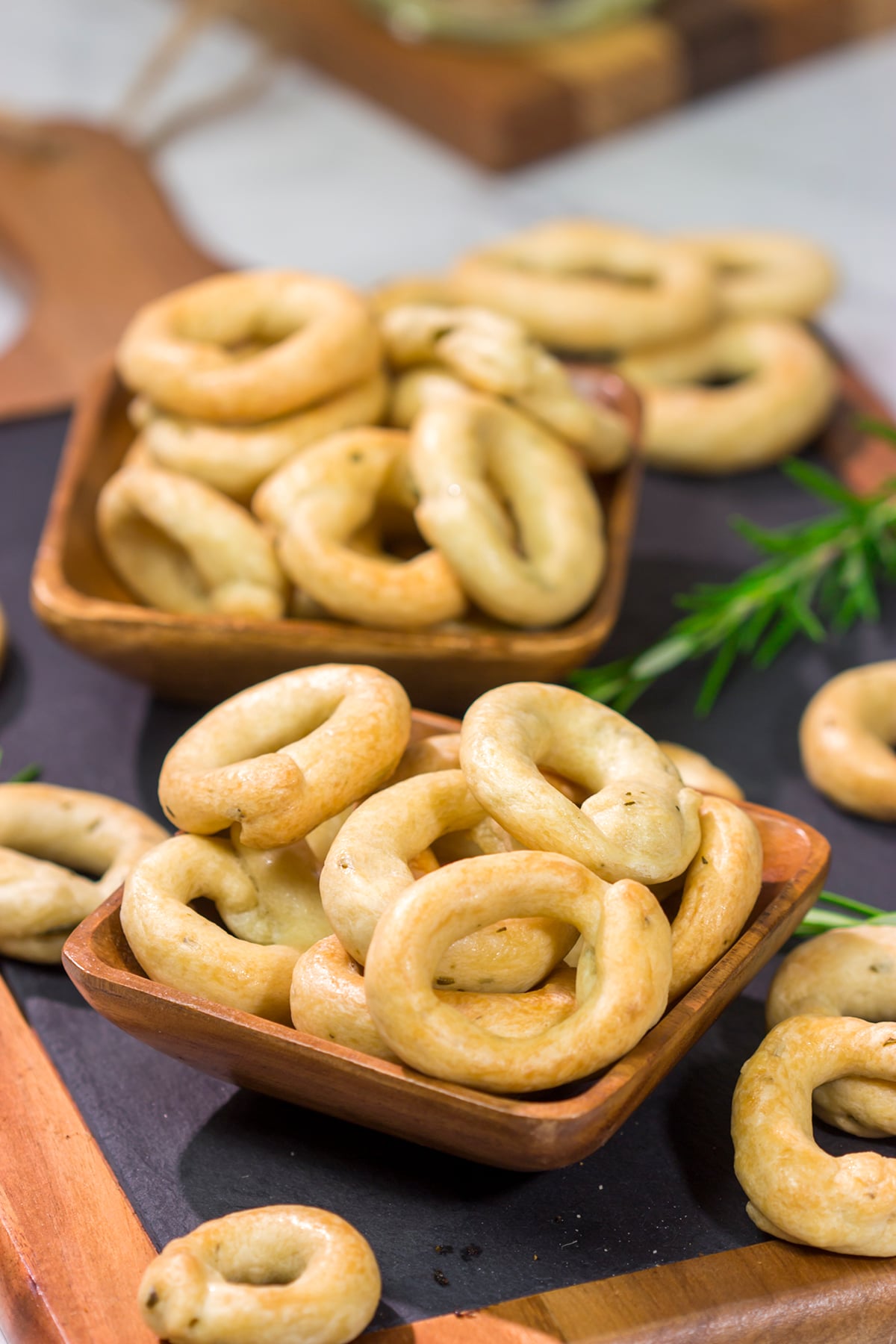 Lightly flavored with olive oil and chopped rosemary, Taralli are the perfect snack to serve alongside a good glass of wine!
