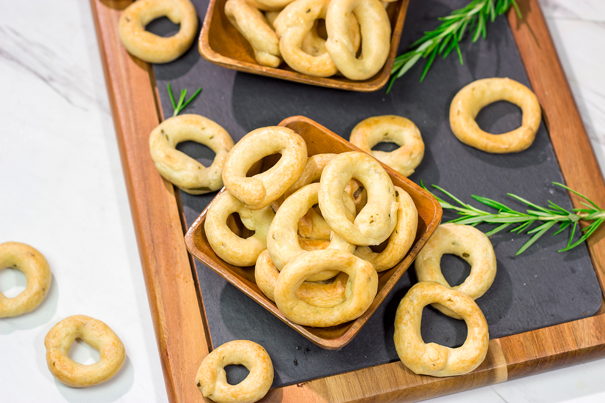 Lightly flavored with olive oil and chopped rosemary, Taralli are the perfect snack to serve alongside a good glass of wine!