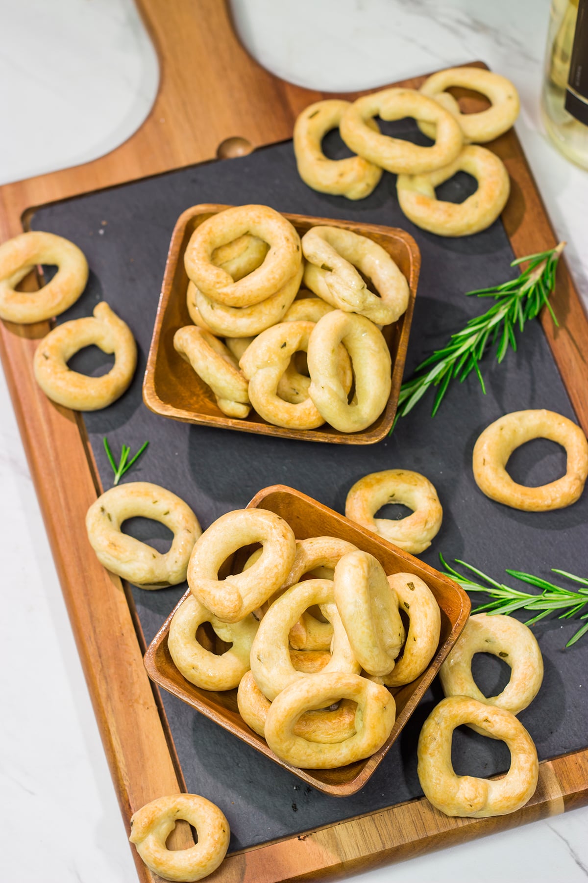 Lightly flavored with olive oil and chopped rosemary, Taralli are the perfect snack to serve alongside a good glass of wine!