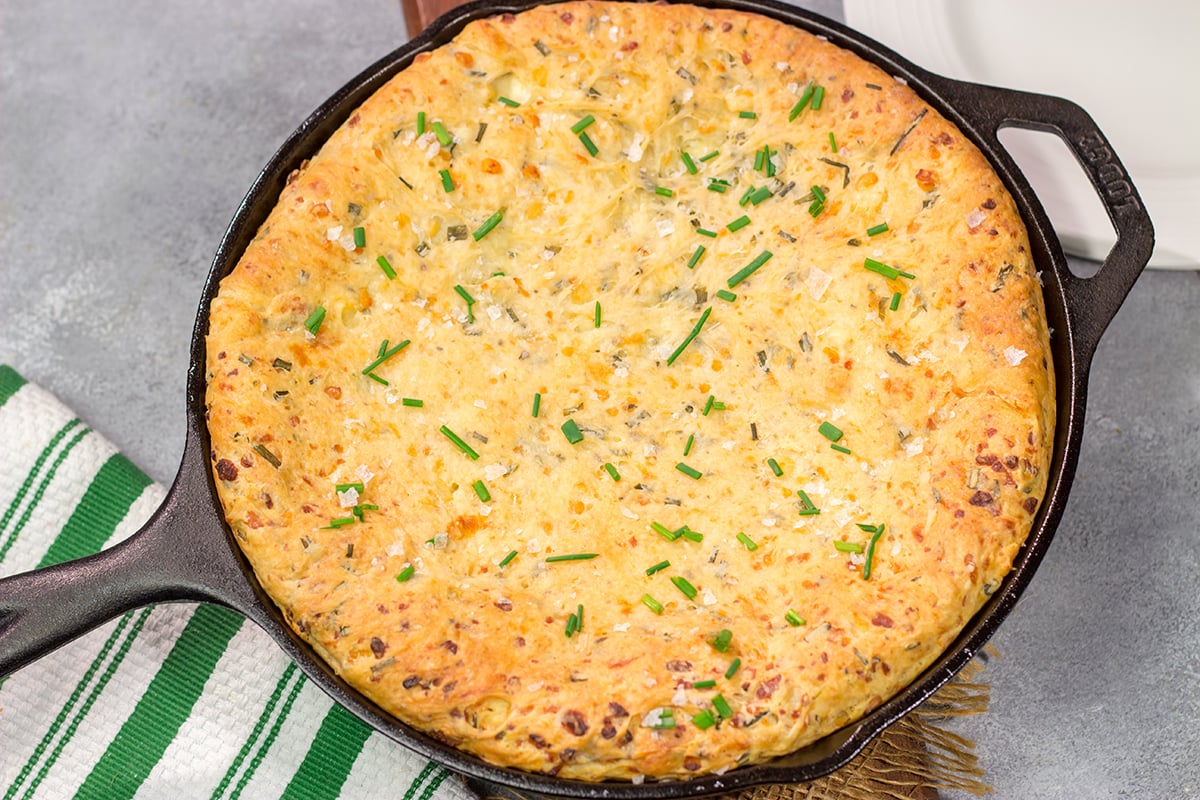 This Cheesy Chive Bread has incredible flavor! This skillet bread is a great side dish alongside a bowl of soup or chili.