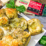 This Cheesy Pesto Pull Apart Bread features freshly baked bread layered with two types of cheese and basil pesto. It's perfect for tailgating or game nights with friends!