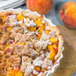 This Peach Crumble Pie features ripe peaches combined with brown sugar and nutmeg. The filling goes on top of a flaky, buttery crust and then a cinnamon sugar crumble gets sprinkled on top. Add a scoop of vanilla ice cream for the perfect summer dessert!