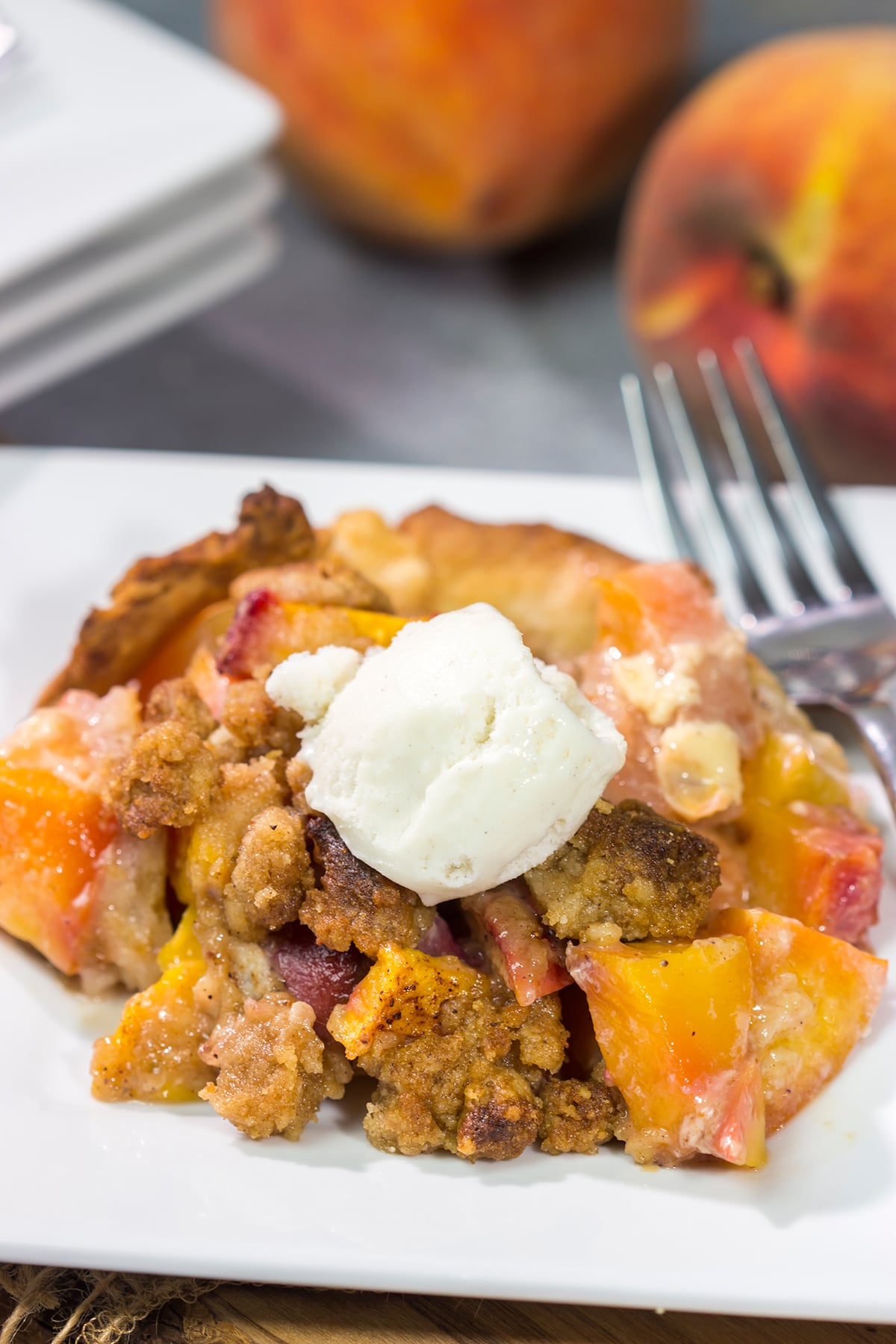 This Peach Crumble Pie features ripe peaches combined with brown sugar and nutmeg. The filling goes on top of a flaky, buttery crust and then a cinnamon sugar crumble gets sprinkled on top. Add a scoop of vanilla ice cream for the perfect summer dessert!