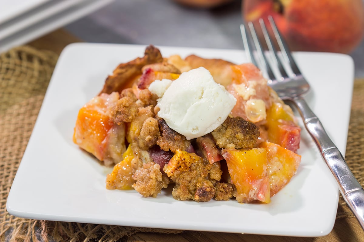 This Peach Crumble Pie features ripe peaches combined with brown sugar and nutmeg. The filling goes on top of a flaky, buttery crust and then a cinnamon sugar crumble gets sprinkled on top. Add a scoop of vanilla ice cream for the perfect summer dessert!