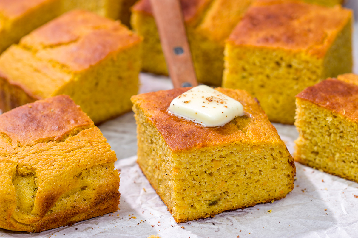 This Sweet Potato Cornbread is the perfect side dish for fall meals. It's a delicious combination of sweet and savory, and it goes well next to barbecue or a hearty bowl of chili!