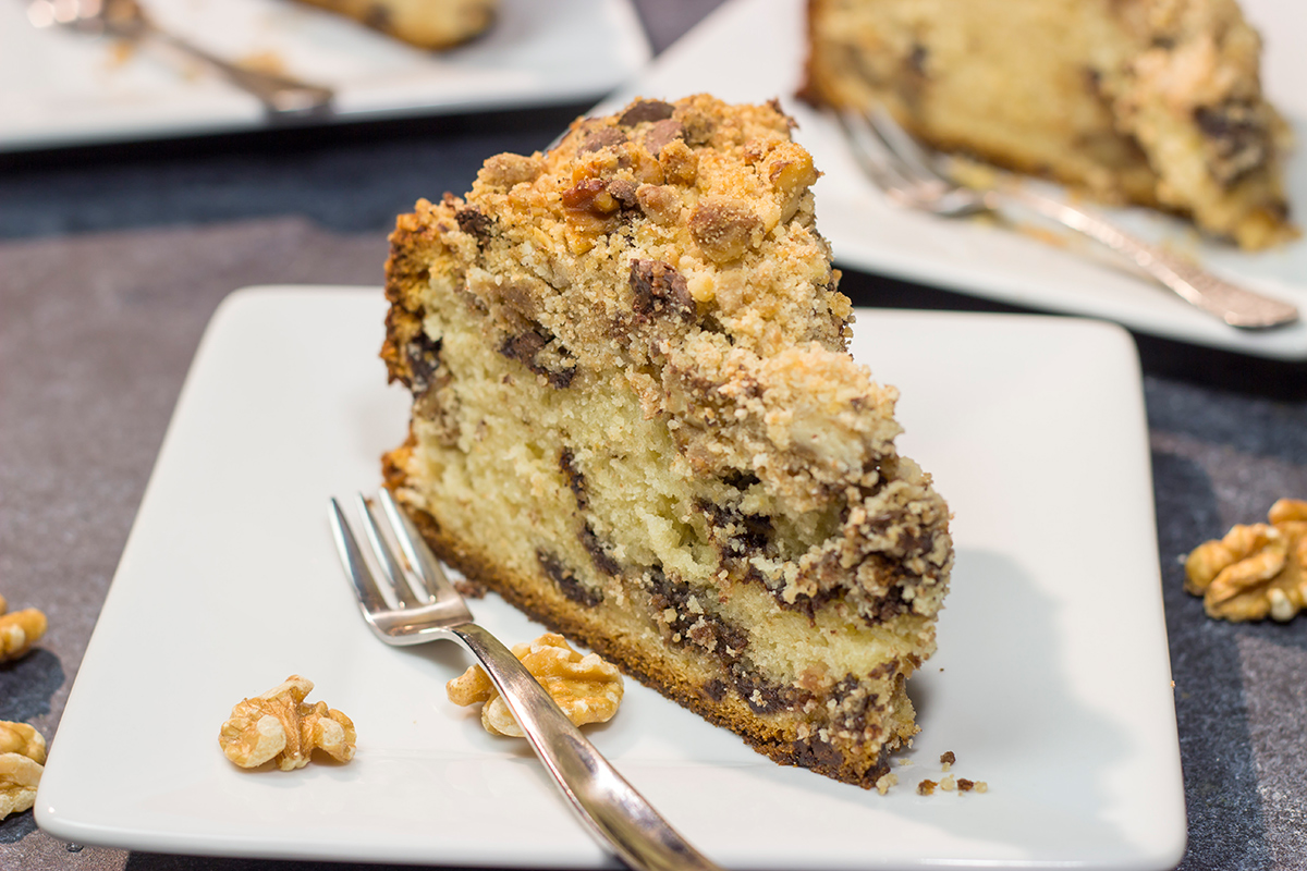 This Chocolate Chip Coffee Cake is soft and tender, and it's topped with an amazing brown sugar + cinnamon streusel. Oh, and it's packed with chocolate chips, too!
