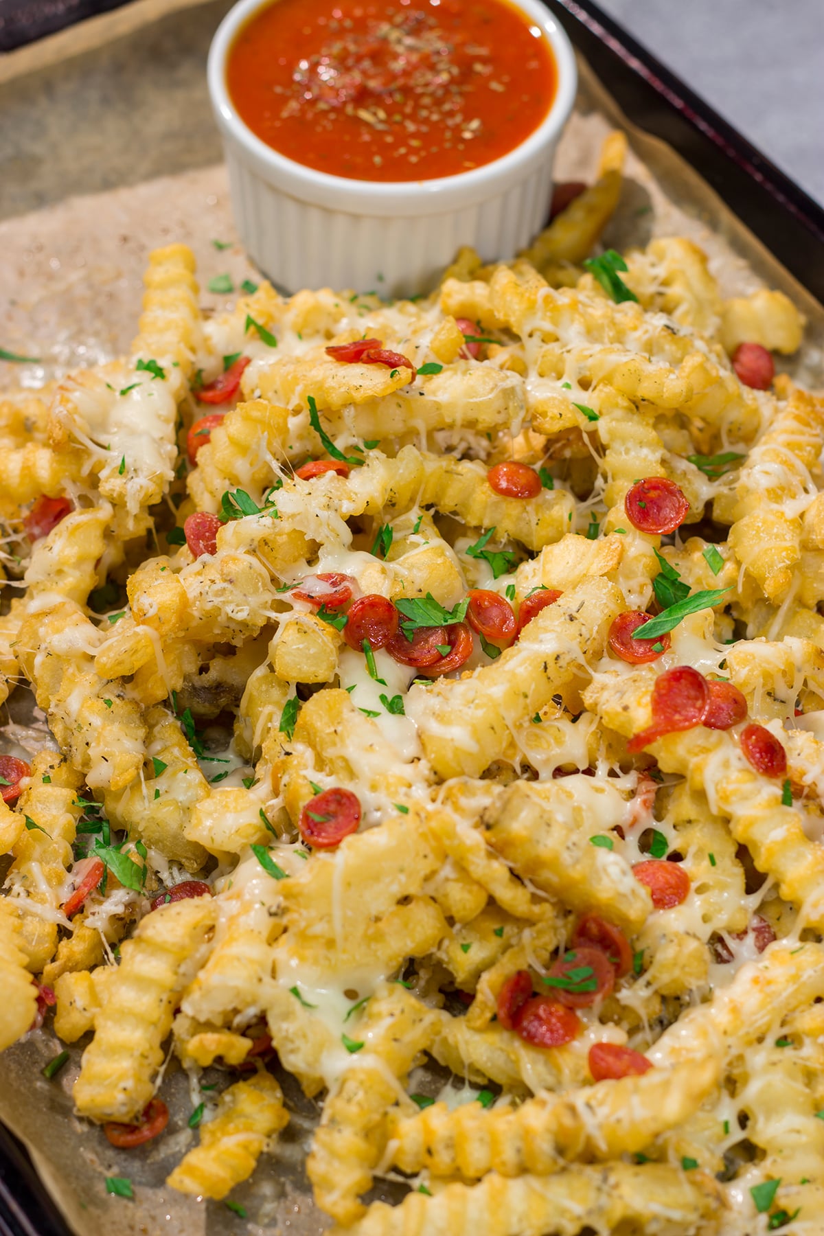 Take game day snacks to a new level! These easy Pepperoni Pizza Fries are loaded with melty cheesy and pepperoni. Leftovers won't be a problem.