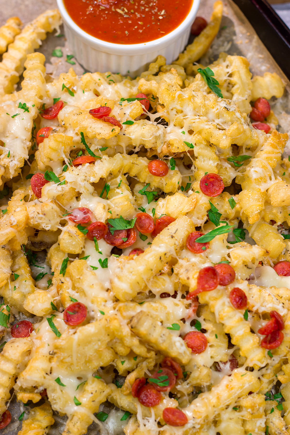 Take game day snacks to a new level! These easy Pepperoni Pizza Fries are loaded with melty cheesy and pepperoni. Leftovers won't be a problem.