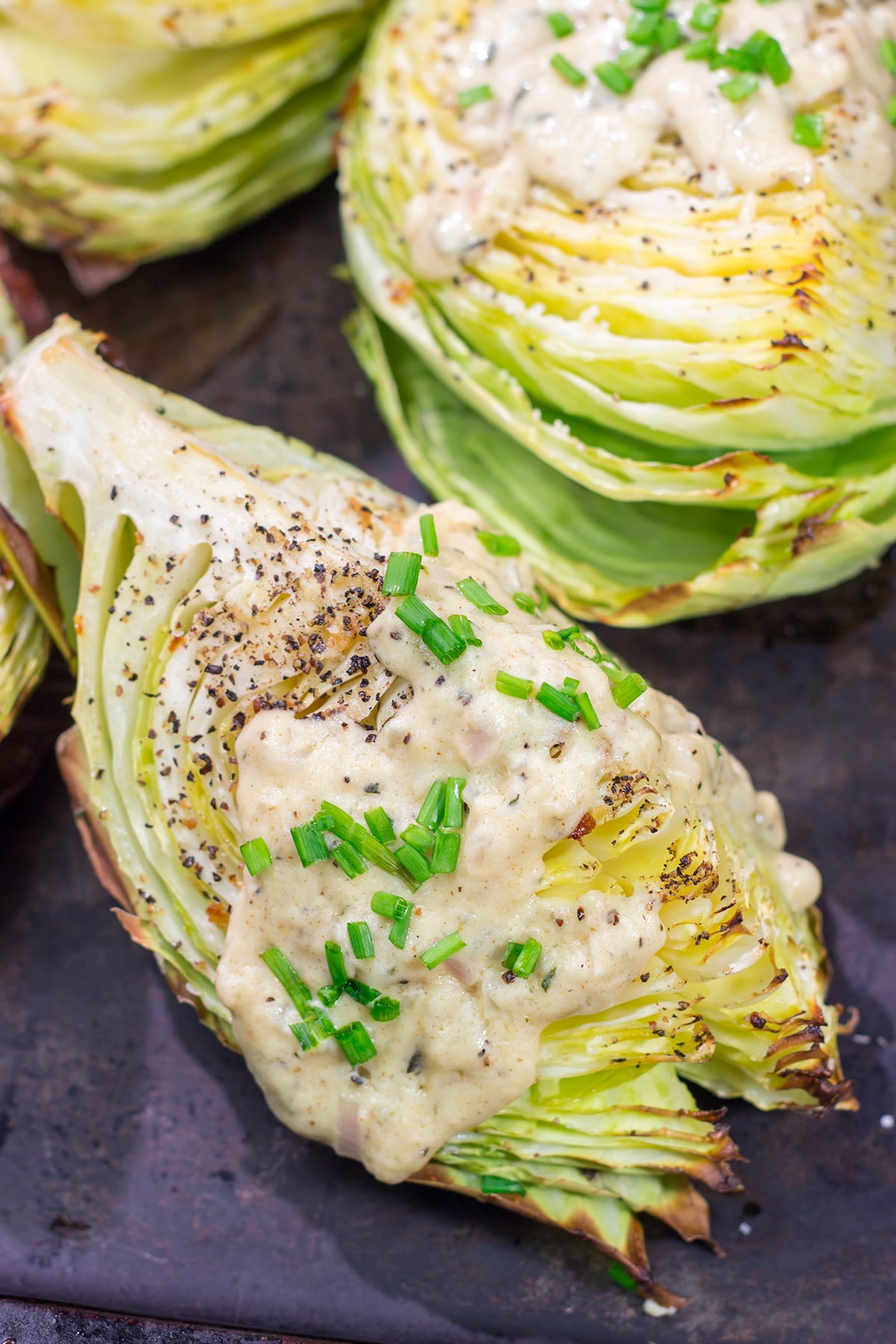 Tired of the same veggies every night? Grab a cabbage! These Roasted Cabbage Wedges get paired with a mustard cream sauce for a unique and delicious side dish!