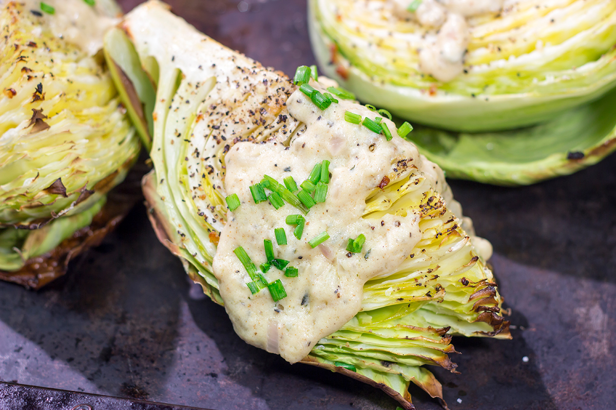 Tired of the same veggies every night? Grab a cabbage! These Roasted Cabbage Wedges get paired with a mustard cream sauce for a unique and delicious side dish!