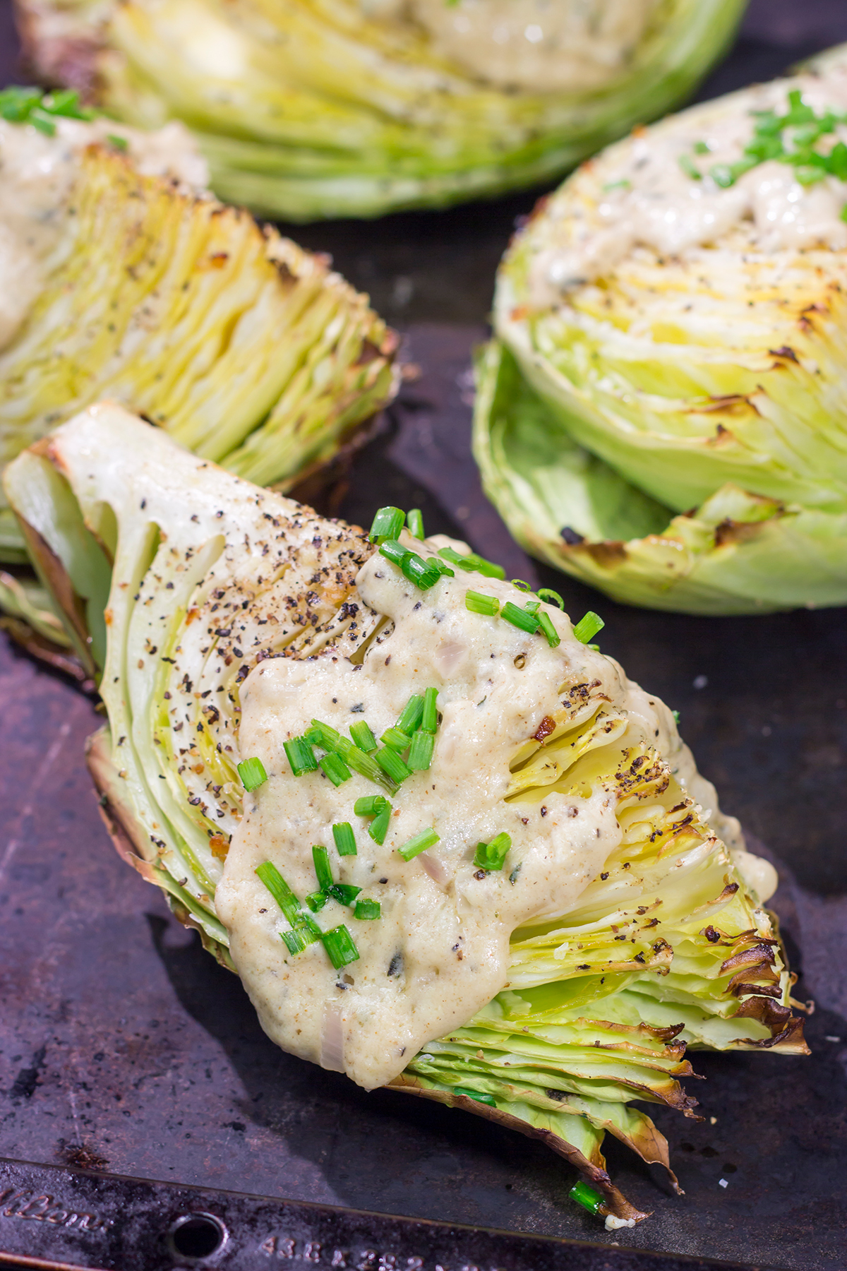 Tired of the same veggies every night? Grab a cabbage! These Roasted Cabbage Wedges get paired with a mustard cream sauce for a unique and delicious side dish!