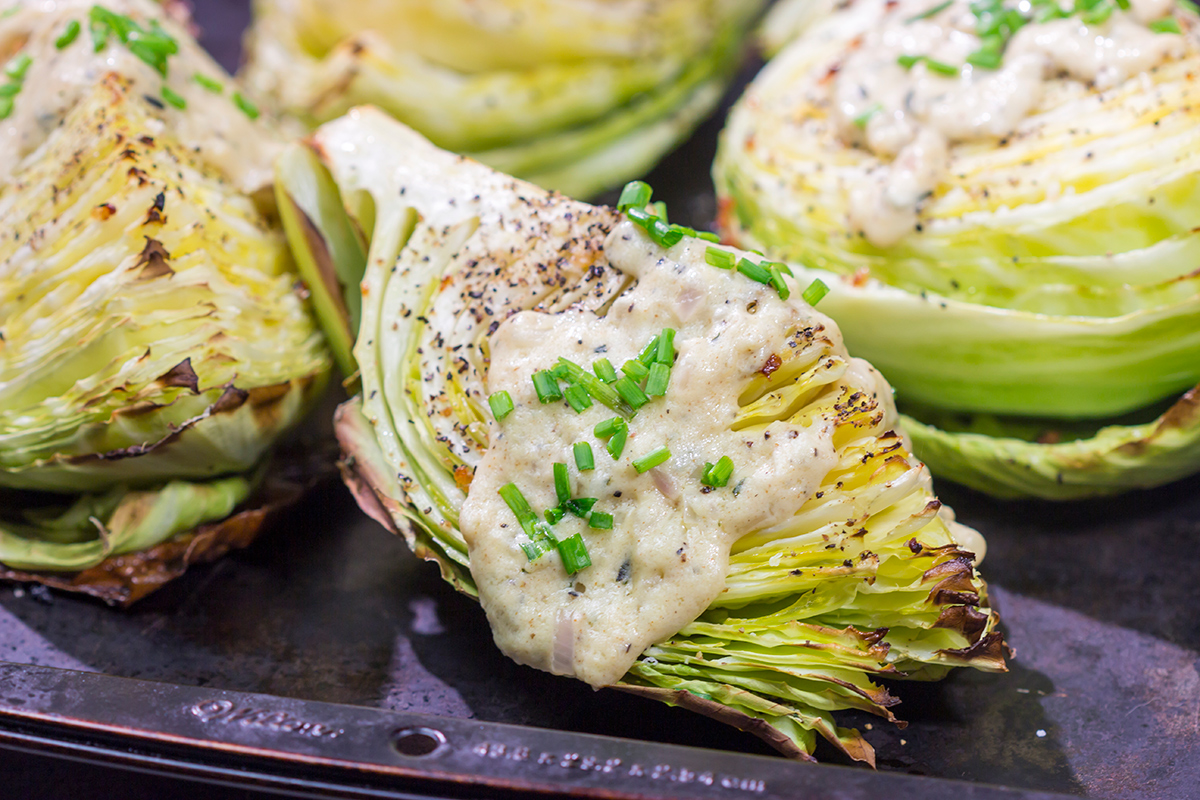 Tired of the same veggies every night? Grab a cabbage! These Roasted Cabbage Wedges get paired with a mustard cream sauce for a unique and delicious side dish!