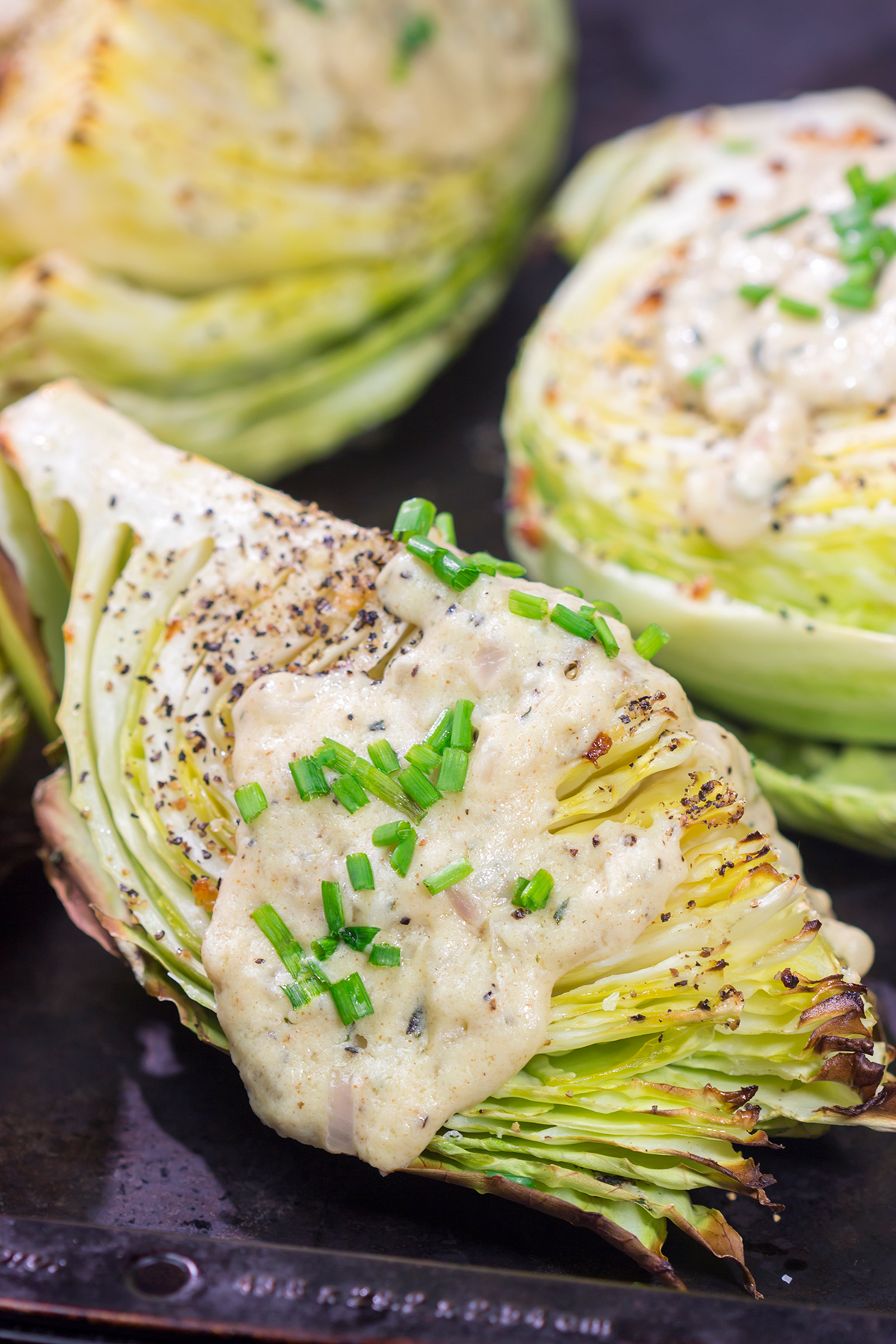 Tired of the same veggies every night? Grab a cabbage! These Roasted Cabbage Wedges get paired with a mustard cream sauce for a unique and delicious side dish!