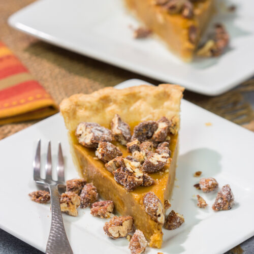 Put a twist on a classic holiday dessert! This Pecan Sweet Potato Pie features a creamy sweet potato pie topped with crunchy sugared pecans. It's delicious!