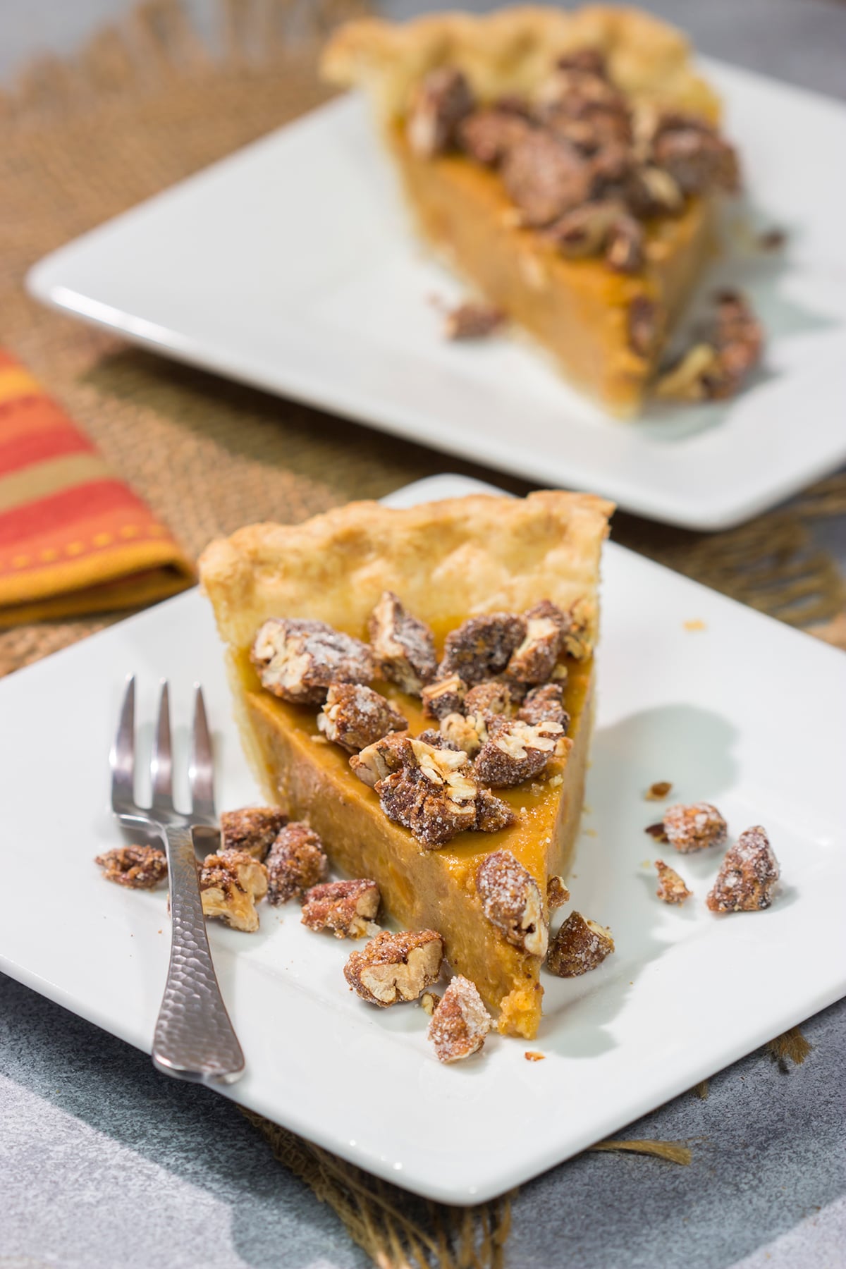 Put a twist on a classic holiday dessert! This Pecan Sweet Potato Pie features a creamy sweet potato pie topped with crunchy sugared pecans. It's delicious!