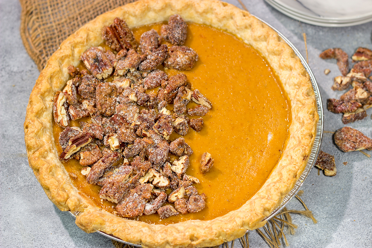 Put a twist on a classic holiday dessert! This Pecan Sweet Potato Pie features a creamy sweet potato pie topped with crunchy sugared pecans. It's delicious!