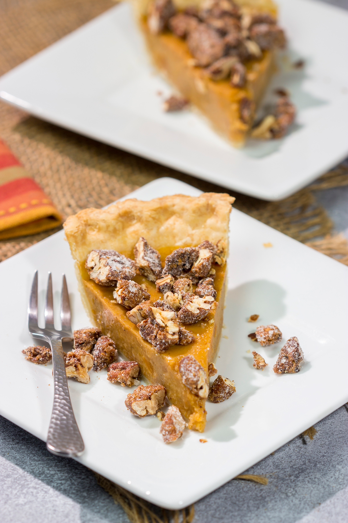 Put a twist on a classic holiday dessert! This Pecan Sweet Potato Pie features a creamy sweet potato pie topped with crunchy sugared pecans. It's delicious!