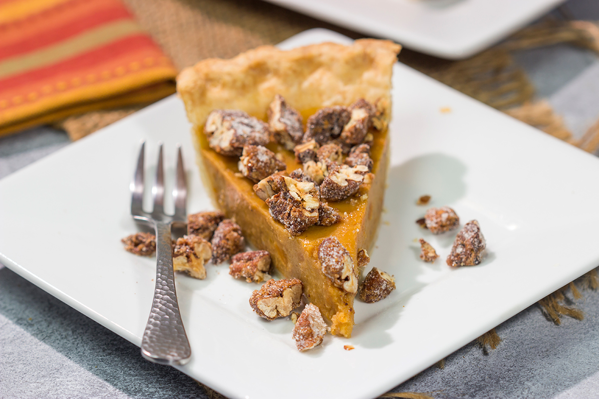 Put a twist on a classic holiday dessert! This Pecan Sweet Potato Pie features a creamy sweet potato pie topped with crunchy sugared pecans. It's delicious!