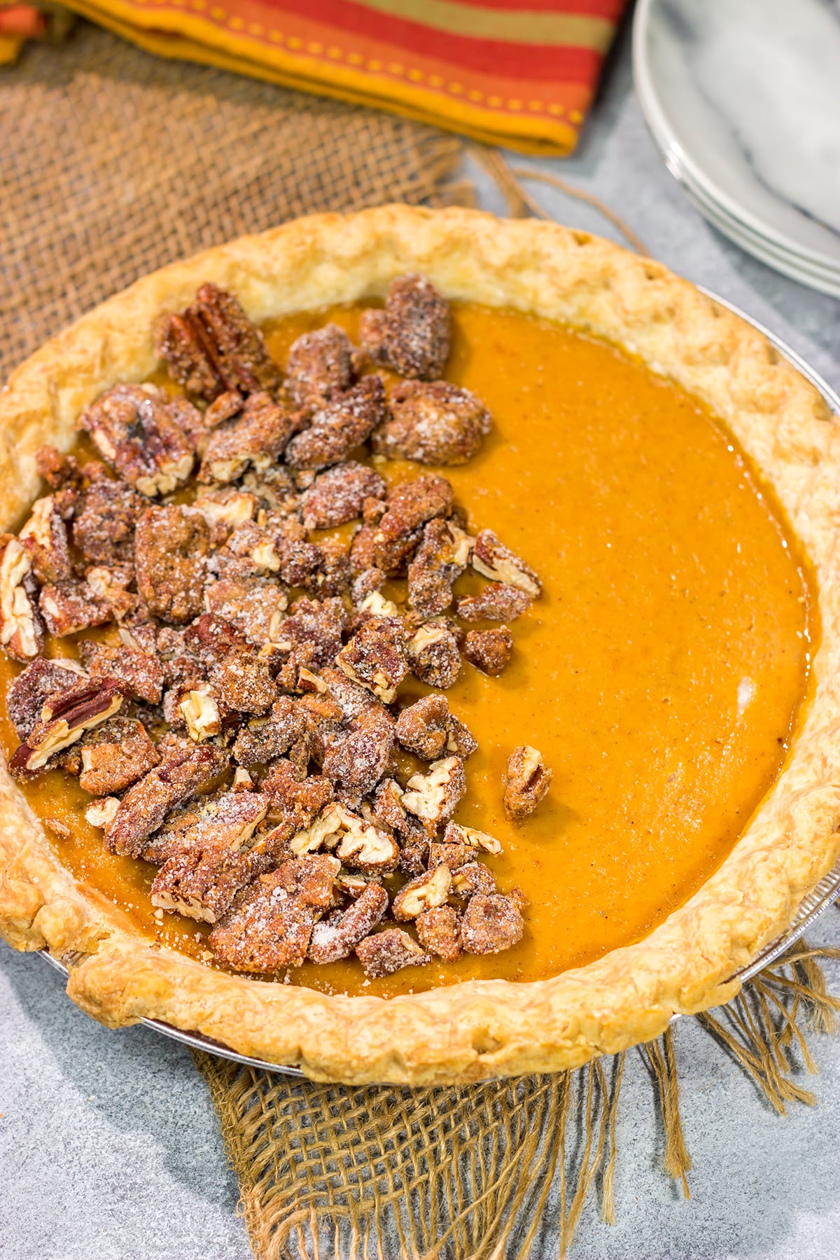 Put a twist on a classic holiday dessert! This Pecan Sweet Potato Pie features a creamy sweet potato pie topped with crunchy sugared pecans. It's delicious!
