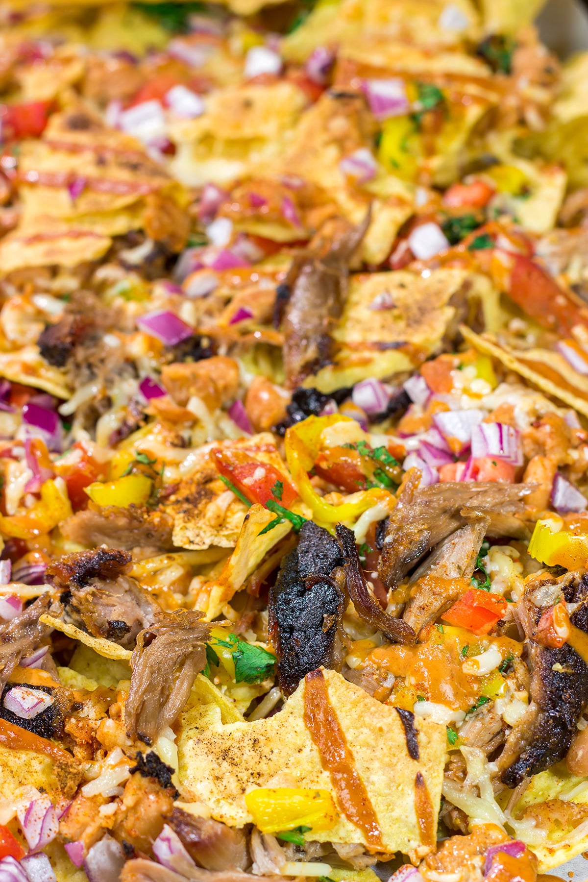 Turn those tortilla chips into a meal by adding smoked meat, BBQ sauce, cheese and all of your favorite toppings. These Loaded BBQ Nachos are a crowd favorite!