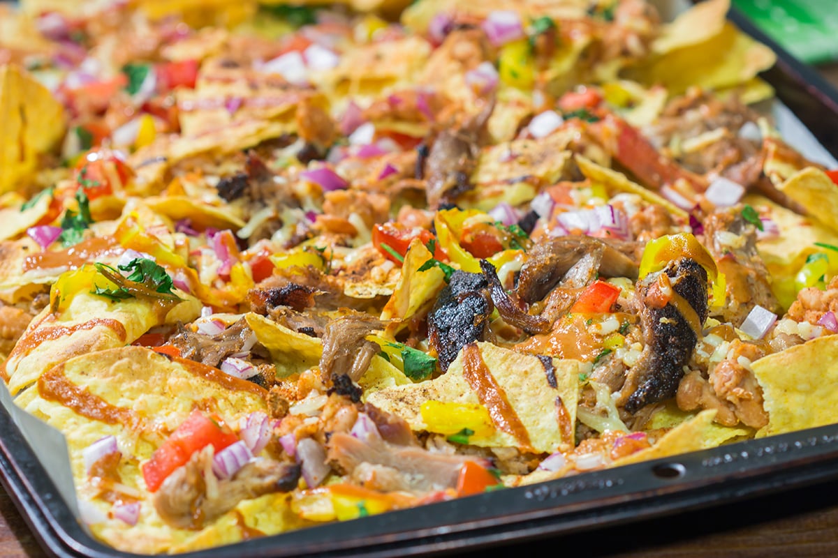 Turn those tortilla chips into a meal by adding smoked meat, BBQ sauce, cheese and all of your favorite toppings. These Loaded BBQ Nachos are a crowd favorite!