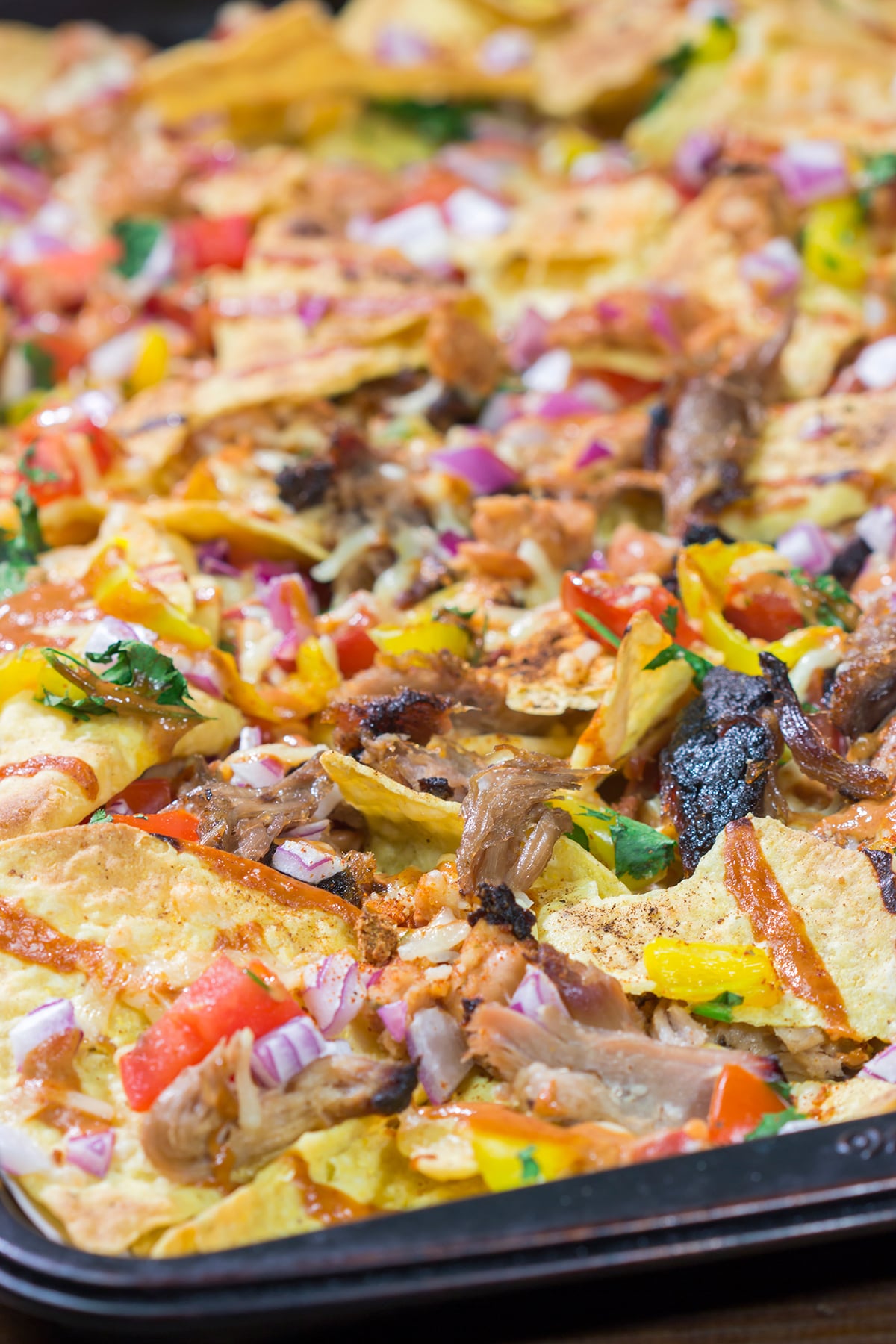 Turn those tortilla chips into a meal by adding smoked meat, BBQ sauce, cheese and all of your favorite toppings. These Loaded BBQ Nachos are a crowd favorite!