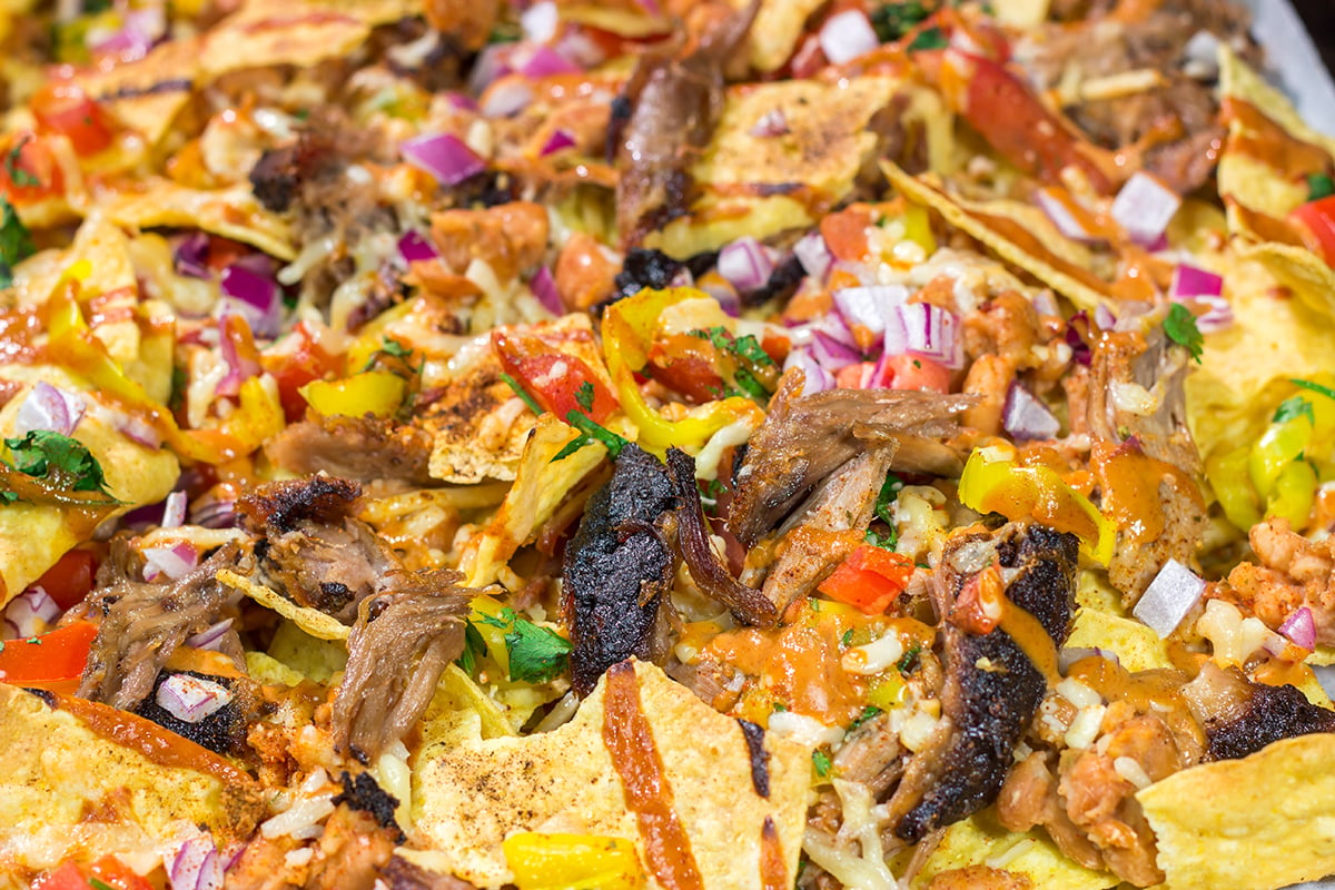 Turn those tortilla chips into a meal by adding smoked meat, BBQ sauce, cheese and all of your favorite toppings. These Loaded BBQ Nachos are a crowd favorite!
