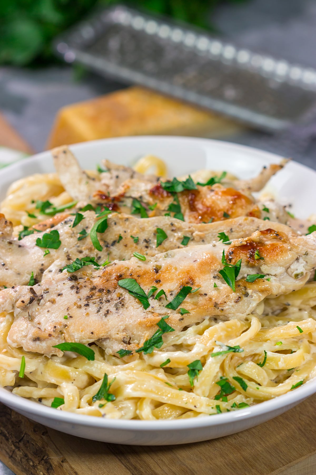 Fettuccine Alfredo features fettuccine pasta tossed with a rich, decadent cream sauce. Make a batch of this classic comfort food for dinner tonight!