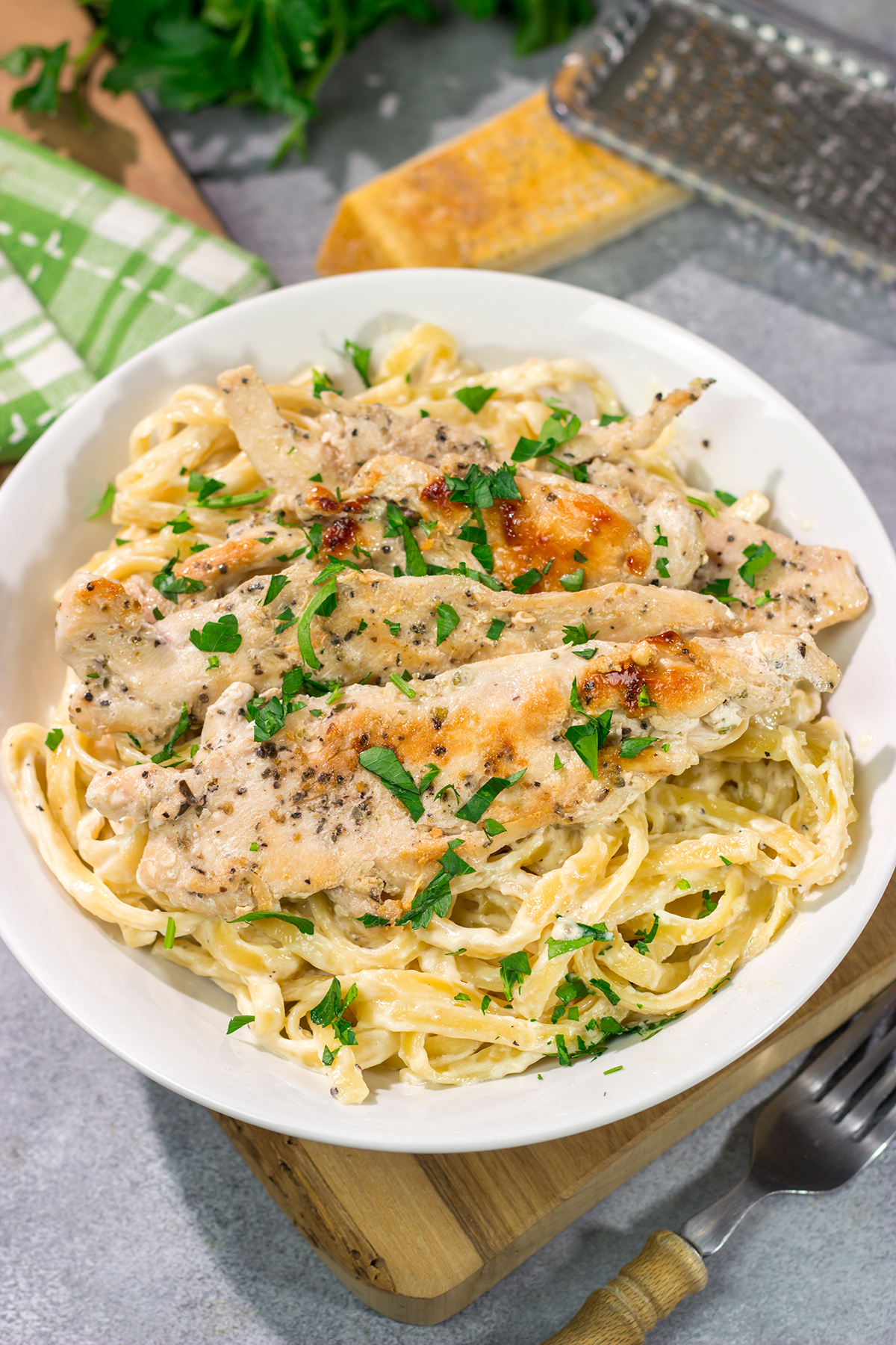 Fettuccine Alfredo features fettuccine pasta tossed with a rich, decadent cream sauce. Make a batch of this classic comfort food for dinner tonight!