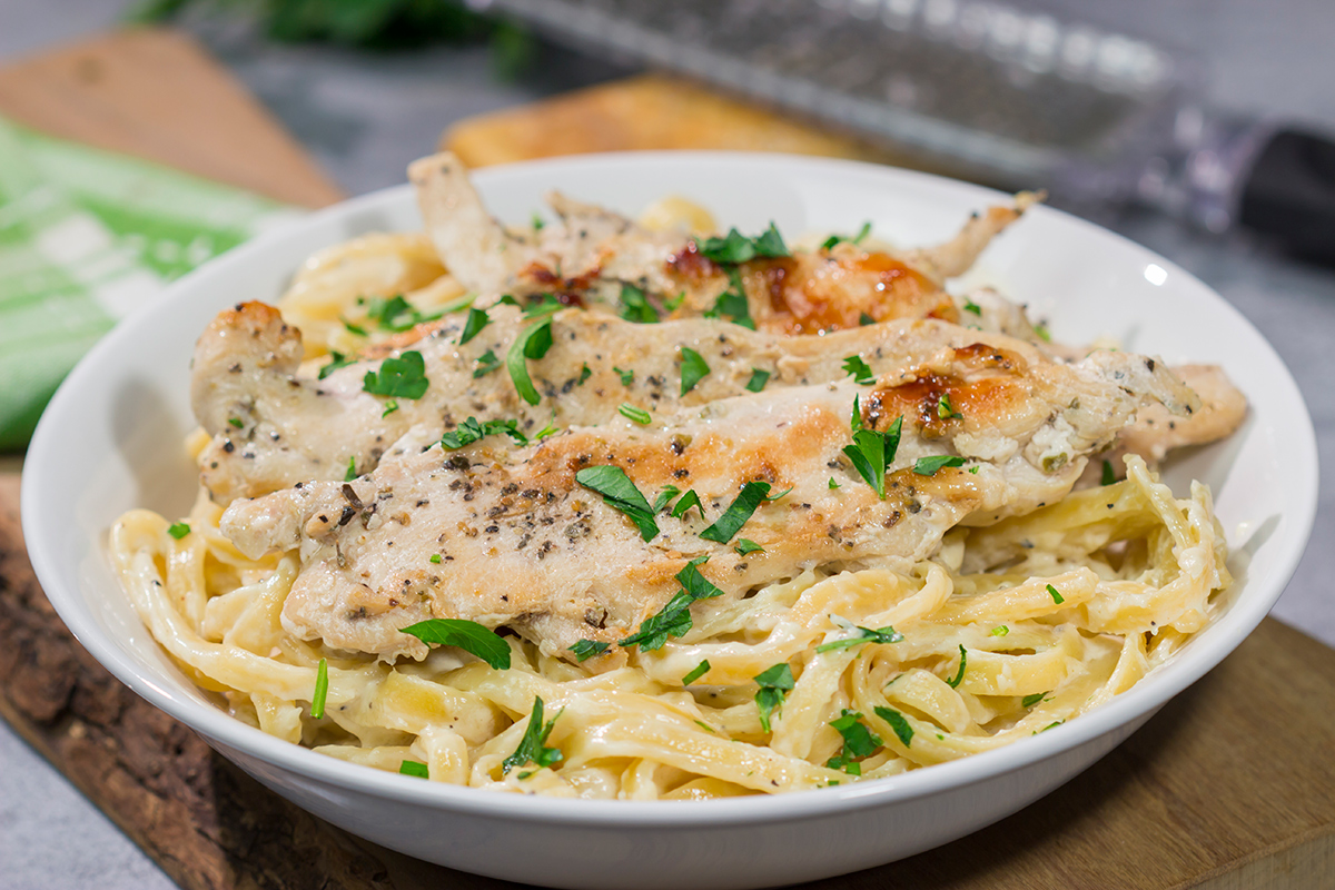 Fettuccine Alfredo features fettuccine pasta tossed with a rich, decadent cream sauce. Make a batch of this classic comfort food for dinner tonight!