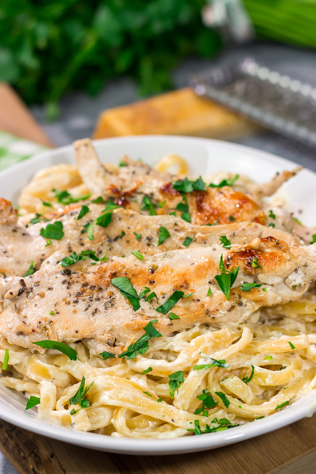 Fettuccine Alfredo features fettuccine pasta tossed with a rich, decadent cream sauce. Make a batch of this classic comfort food for dinner tonight!