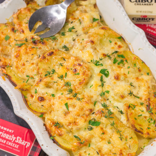 This Cheesy Scalloped Potatoes recipe features layers of potatoes, onions and shredded cheddar cheese. It's a fantastic side dish for dinner!