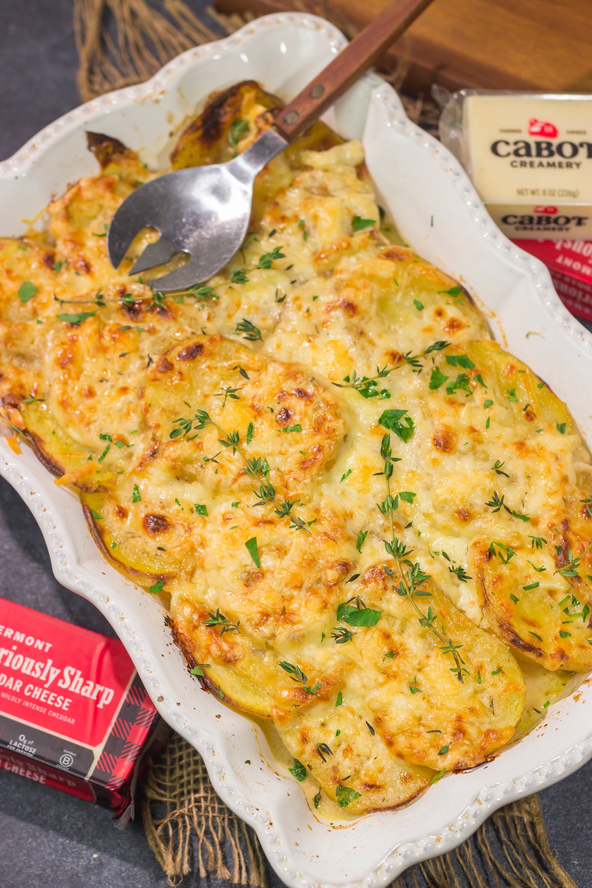 This Cheesy Scalloped Potatoes recipe features layers of potatoes, onions and shredded cheddar cheese. It's a fantastic side dish for dinner!