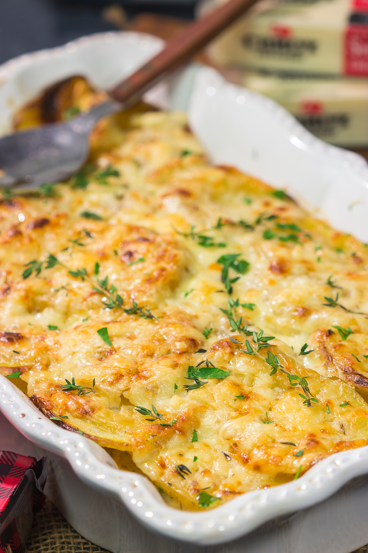 This Cheesy Scalloped Potatoes recipe features layers of potatoes, onions and shredded cheddar cheese. It's a fantastic side dish for dinner!