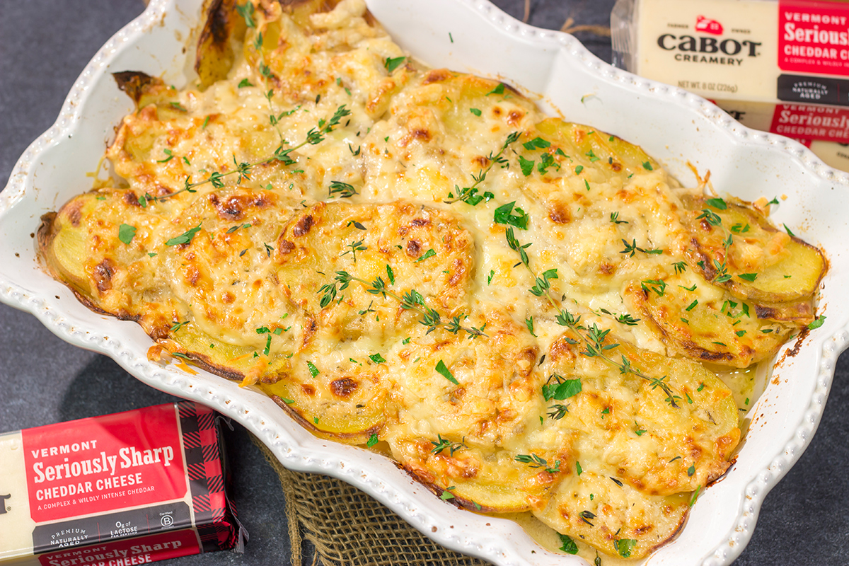 This Cheesy Scalloped Potatoes recipe features layers of potatoes, onions and shredded cheddar cheese. It's a fantastic side dish for dinner!