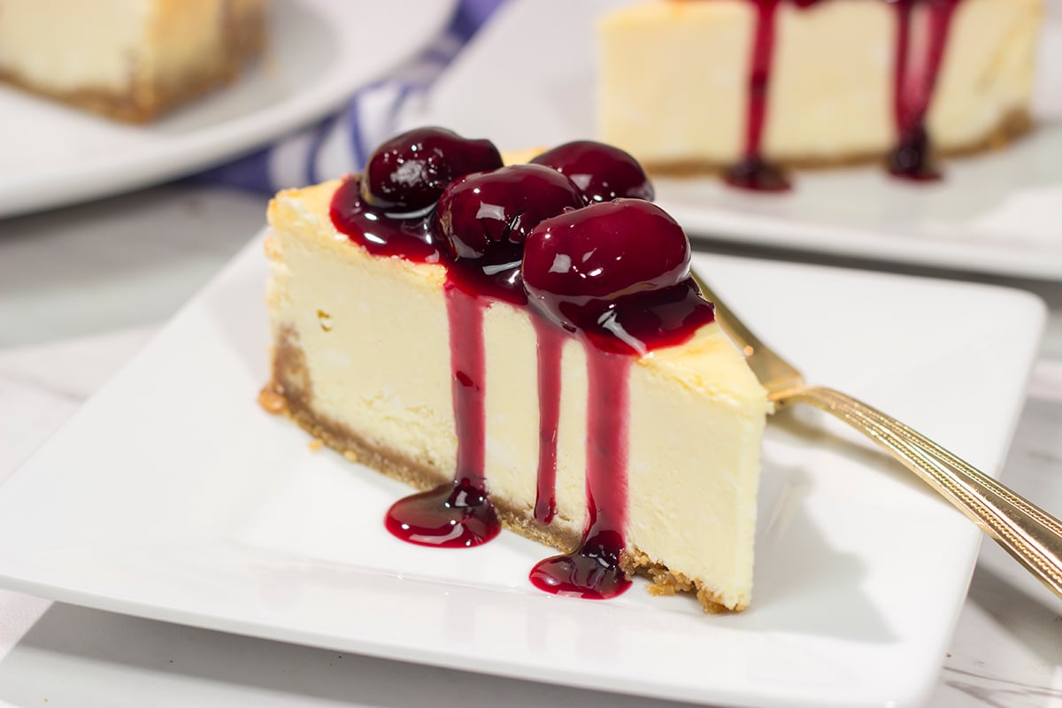 Featuring a creamy cheesecake base topping with an easy homemade cherry sauce, a slice of this Cherry Cheesecake makes for a delicious dessert. It's a classic for a reason!