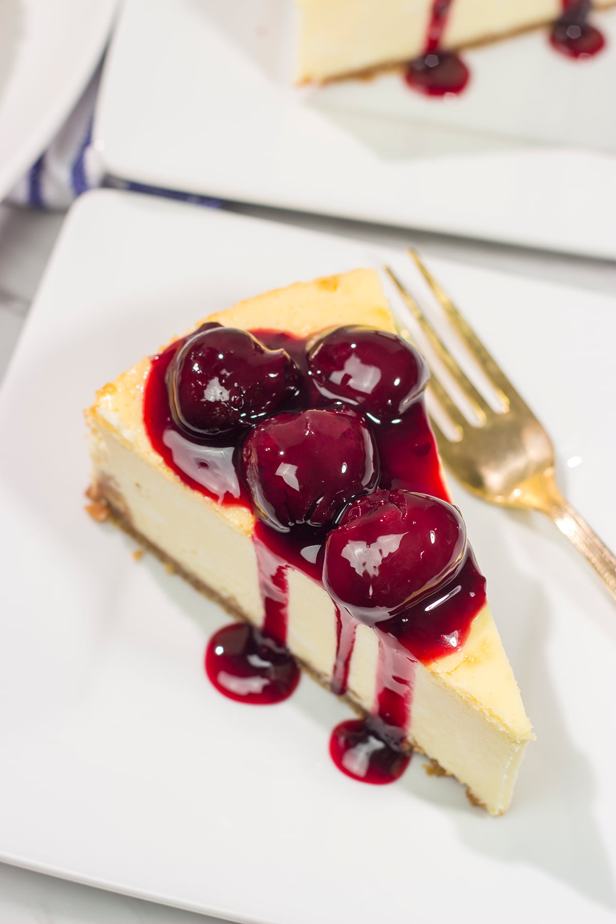 Featuring a creamy cheesecake base topping with an easy homemade cherry sauce, a slice of this Cherry Cheesecake makes for a delicious dessert. It's a classic for a reason!