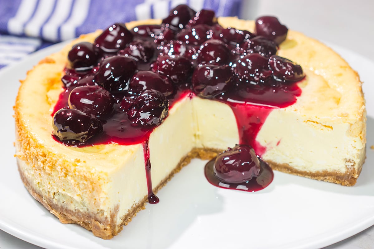 Featuring a creamy cheesecake base topping with an easy homemade cherry sauce, a slice of this Cherry Cheesecake makes for a delicious dessert. It's a classic for a reason!