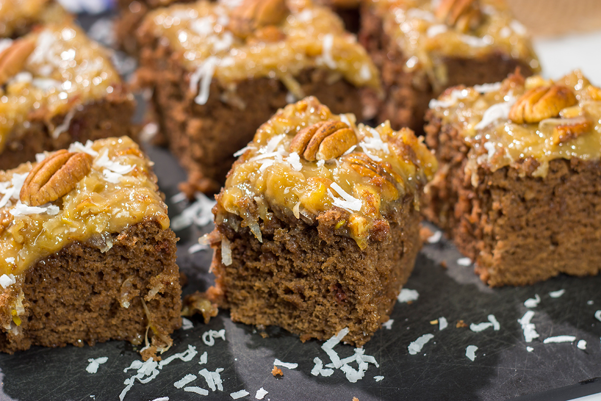This sheet pan version of the classic German Chocolate Cake features a mild chocolate cake topped with a gooey coconut pecan frosting. It's perfect for picnics and family gatherings!