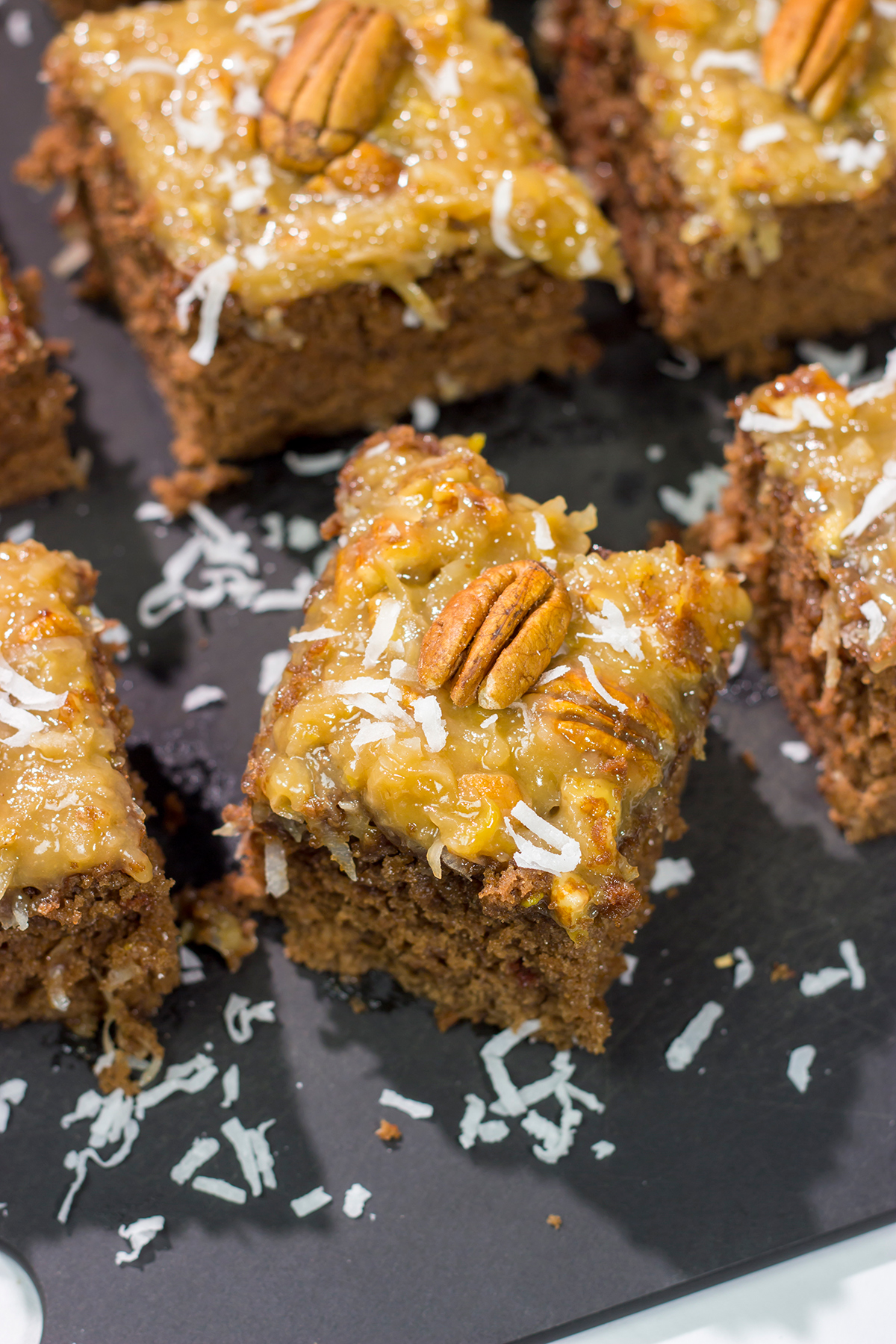 This sheet pan version of the classic German Chocolate Cake features a mild chocolate cake topped with a gooey coconut pecan frosting. It's perfect for picnics and family gatherings!