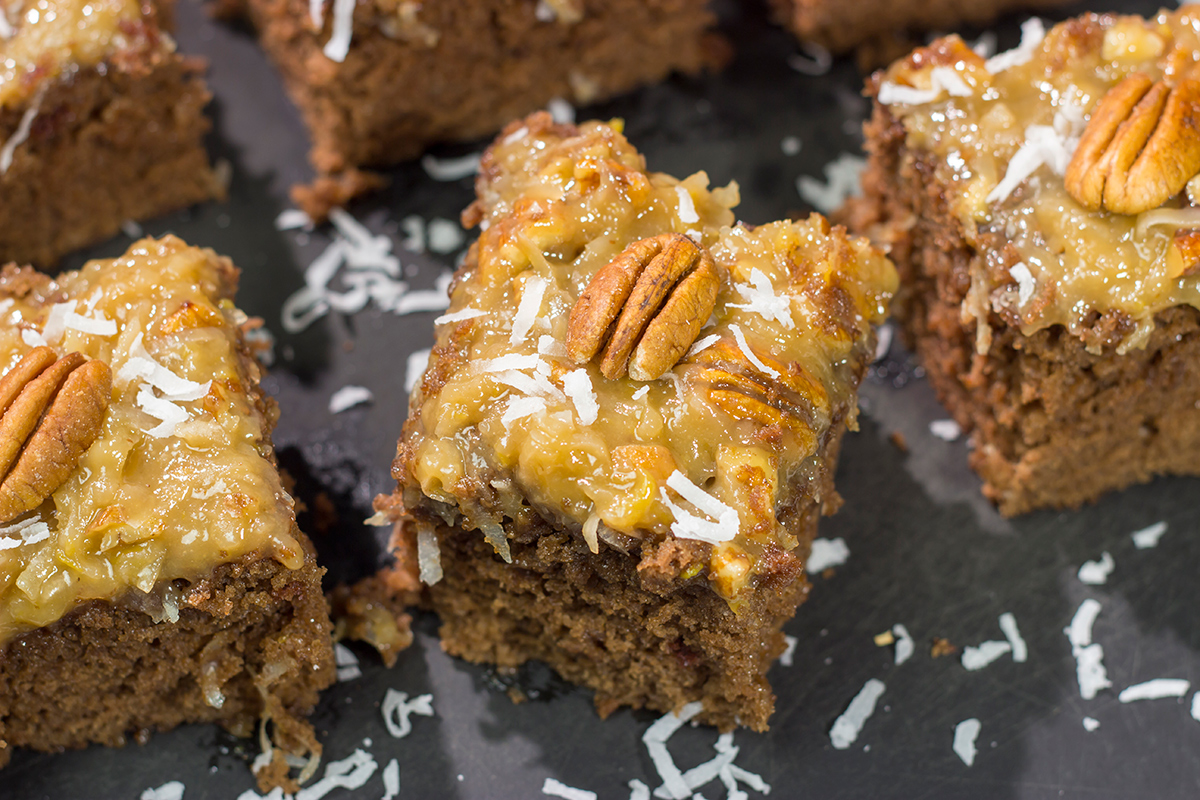 This sheet pan version of the classic German Chocolate Cake features a mild chocolate cake topped with a gooey coconut pecan frosting. It's perfect for picnics and family gatherings!