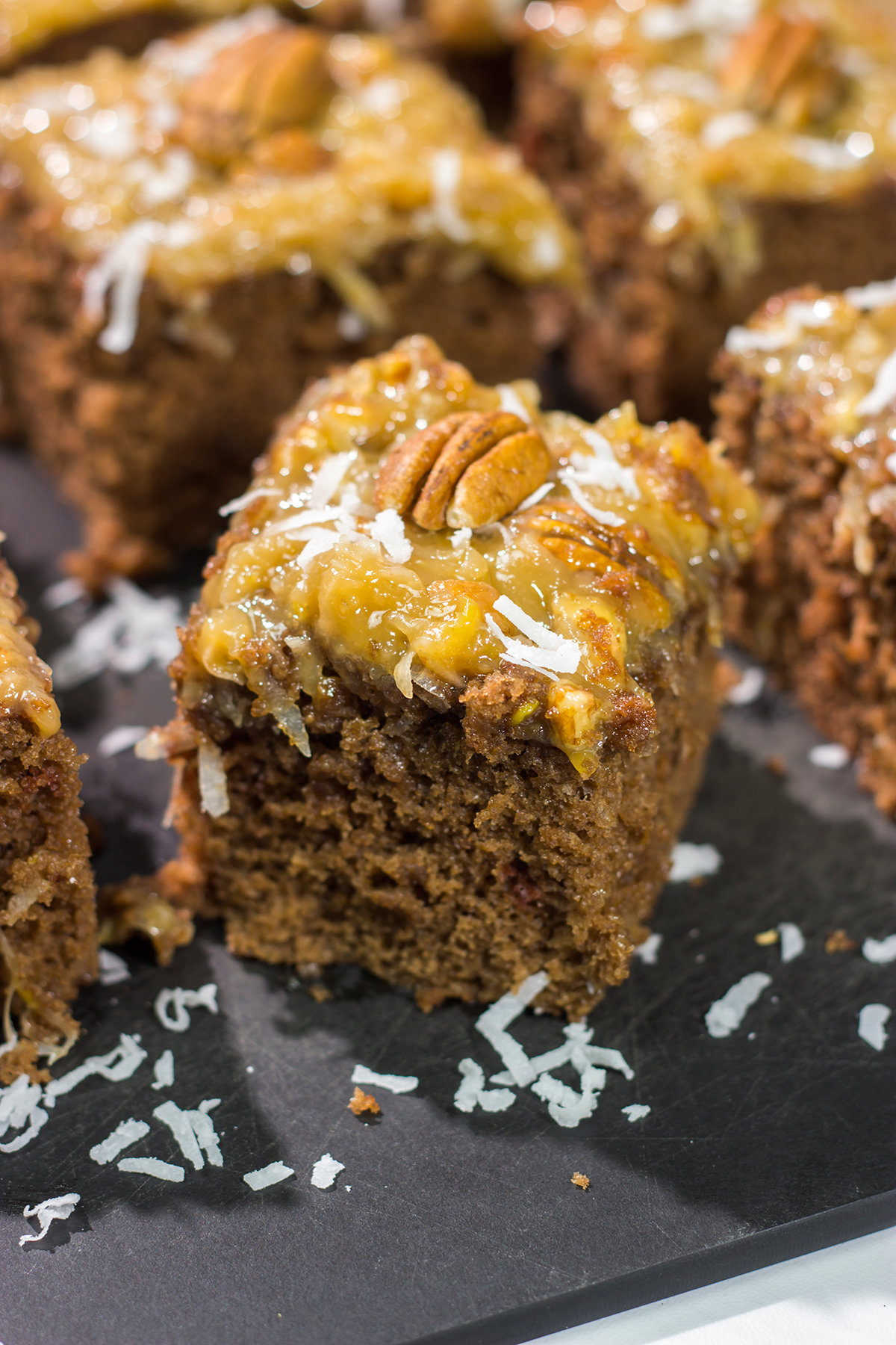 This sheet pan version of the classic German Chocolate Cake features a mild chocolate cake topped with a gooey coconut pecan frosting. It's perfect for picnics and family gatherings!