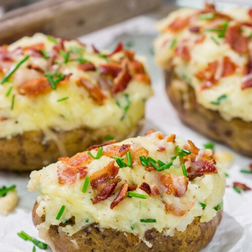 These Grilled Twice-Baked Potatoes feature crispy potato skins filled with creamy mashed potatoes combined with all of your favorite toppings. Add in the grill flavor and you've got one heck of a recipe!