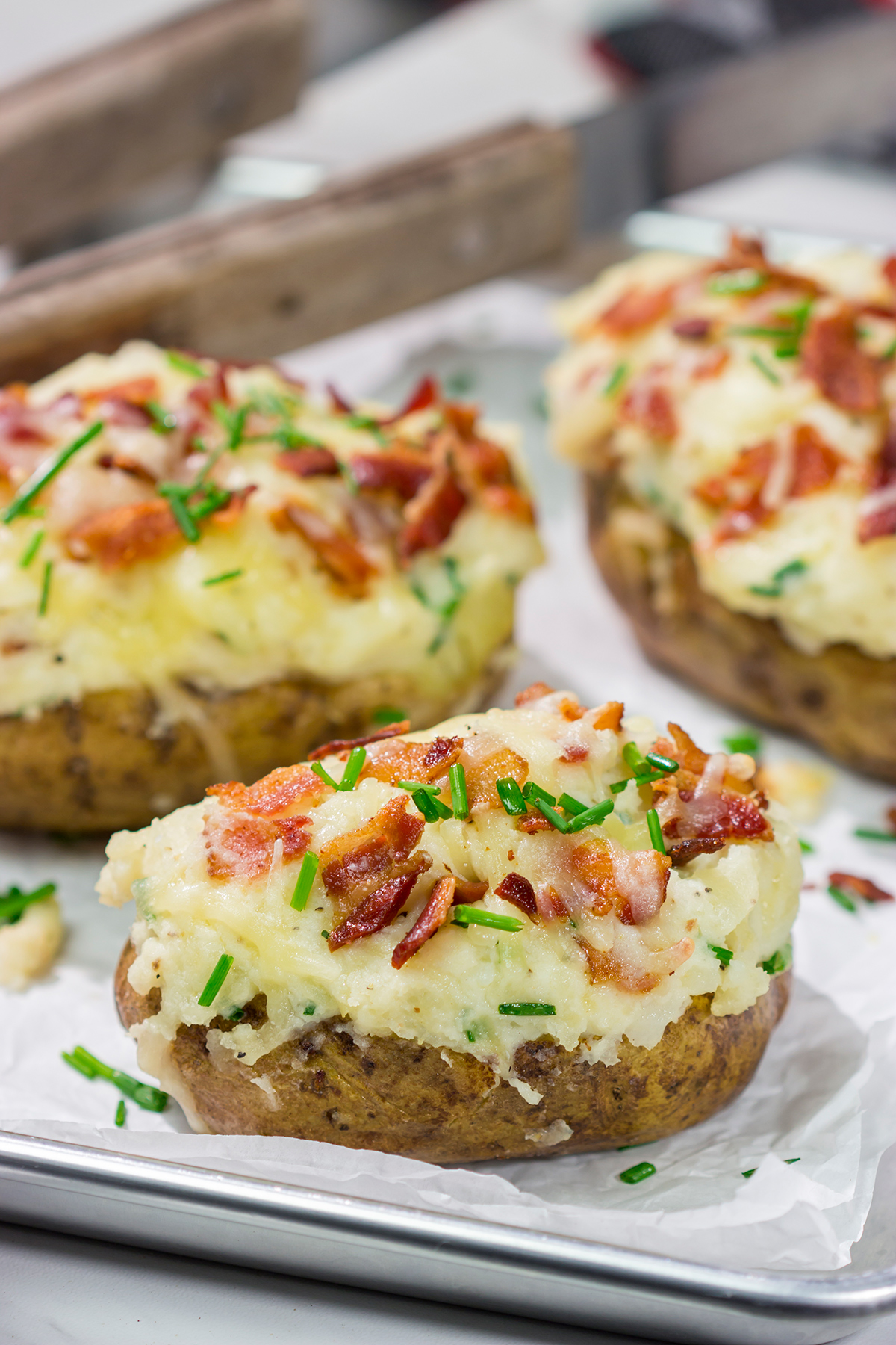 These Grilled Twice-Baked Potatoes feature crispy potato skins filled with creamy mashed potatoes combined with all of your favorite toppings. Add in the grill flavor and you've got one heck of a recipe!