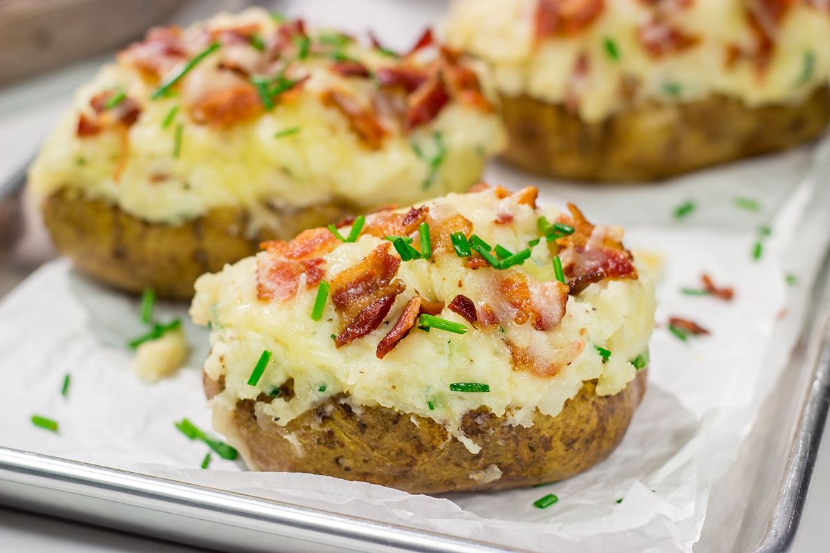 These Grilled Twice-Baked Potatoes feature crispy potato skins filled with creamy mashed potatoes combined with all of your favorite toppings. Add in the grill flavor and you've got one heck of a recipe!