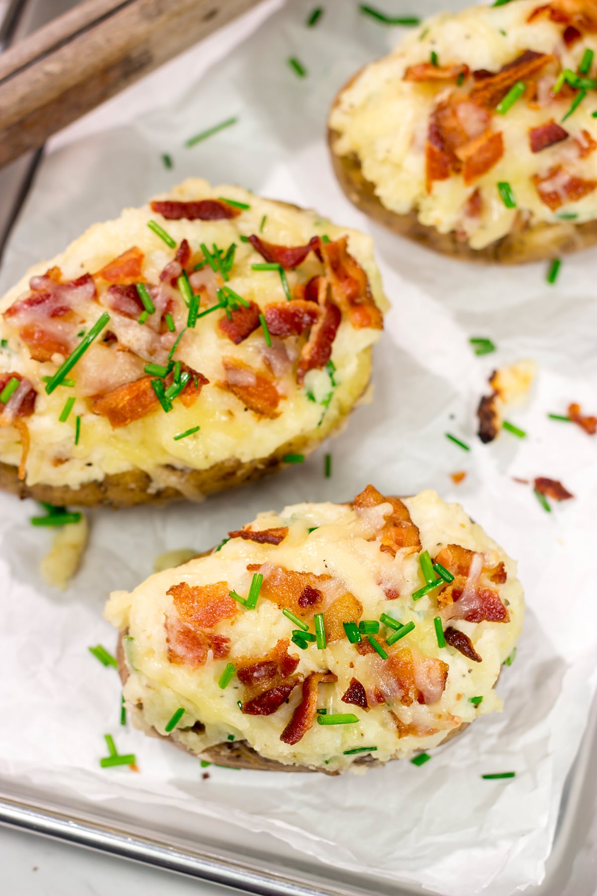 These Grilled Twice-Baked Potatoes feature crispy potato skins filled with creamy mashed potatoes combined with all of your favorite toppings. Add in the grill flavor and you've got one heck of a recipe!