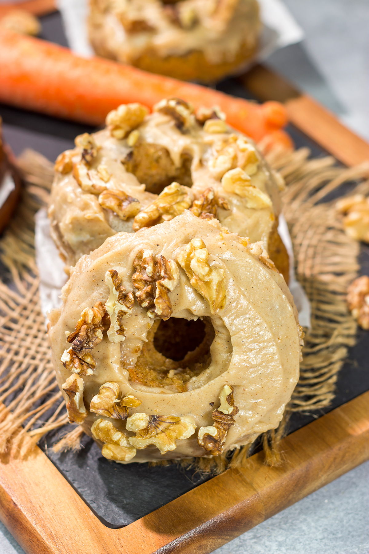 These baked Carrot Cake Donuts feature a tender and delicious donut topped with a creamy brown sugar + cream cheese frosting. These donuts are perfect for Easter!