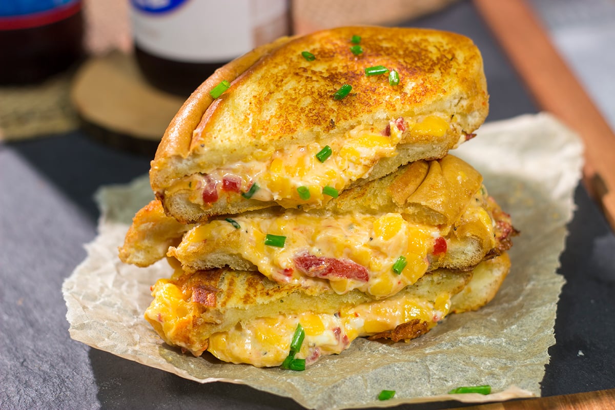 Take an old classic to a new level! These Pimento Grilled Cheese Sandwiches feature melty, creamy pimento cheese in between slices of buttered bread. Yum!